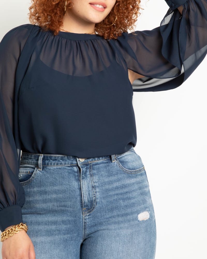 Front of a model wearing a size 14 Georgie Open Tie Sleeve Blouse in Navy by ELOQUII. | dia_product_style_image_id:217021